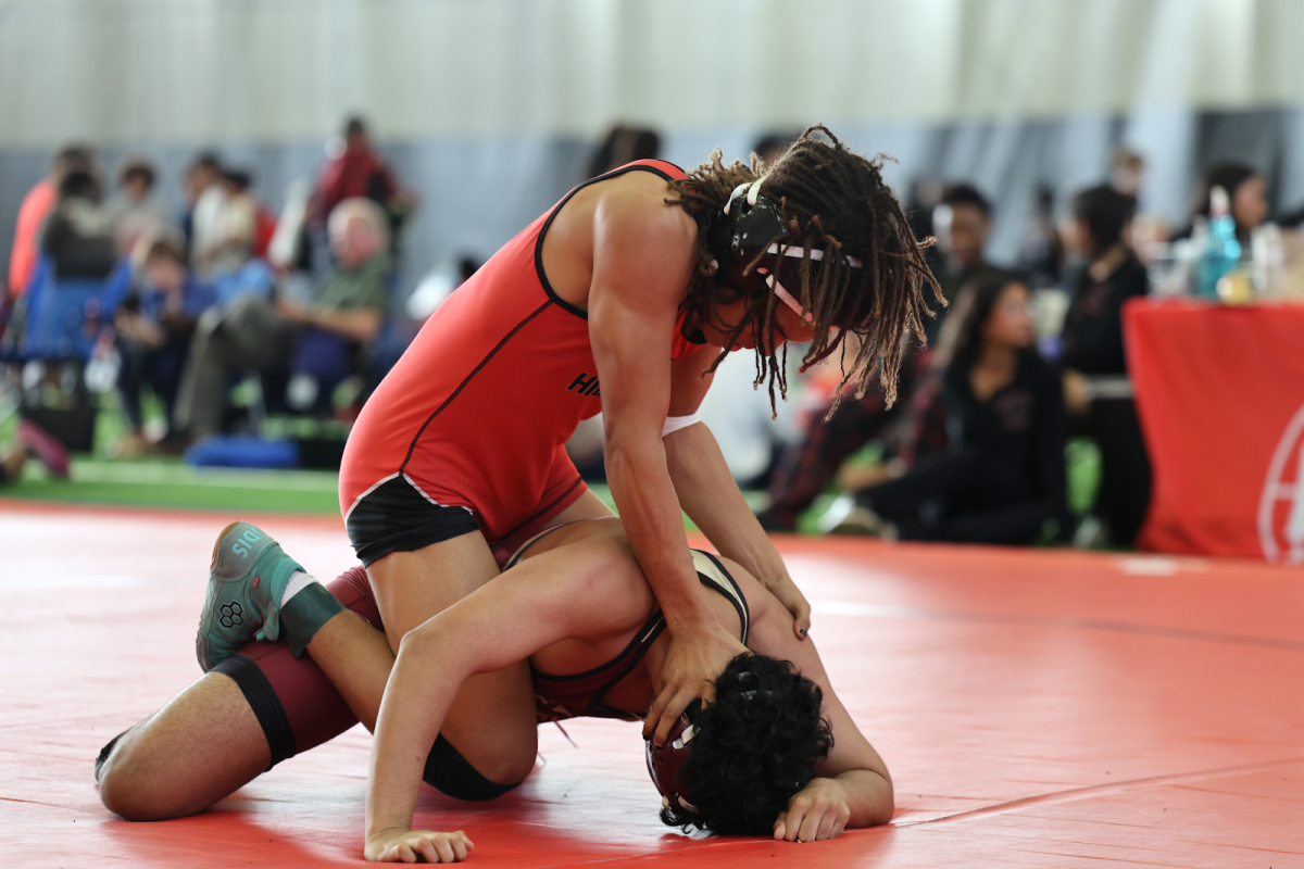 In the final period of his match, Daelyn Spencer (10) shoves his opponent down to secure the victory.